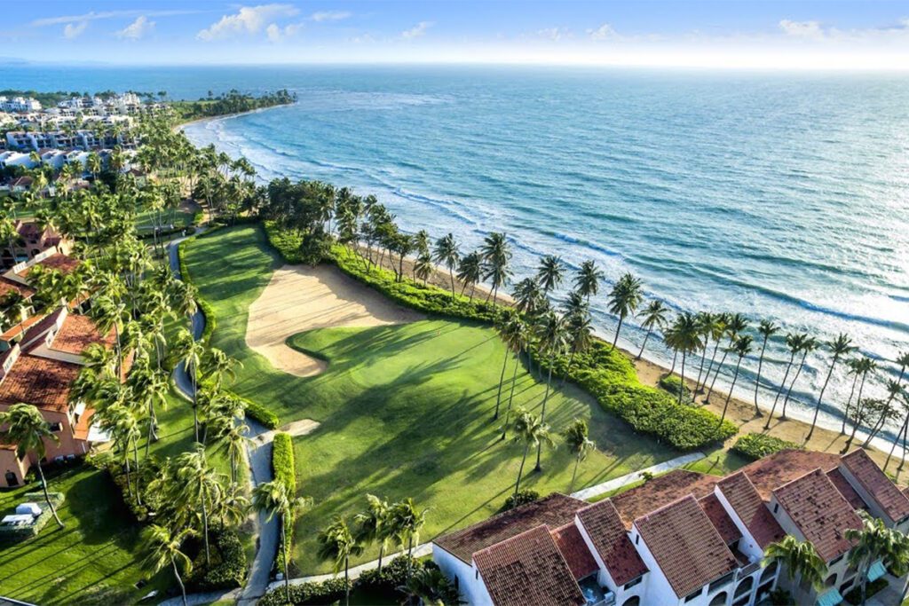 It’s always been one of the best golf resorts in Puerto Rico. Now, the Wyndham Palmas resort has a bigger ambition: to be one of the island’s best resorts, period. The new-look Wyndham Palmas will be reopening its doors this May following a “dramatic” transformation, Caribbean Journal has learned. The Wyndham Palmas Beach and Golf Resort is set to complete its renovation and reopen on May 18, 2023. The multimillion-dollar renovation comes after the resort was acquired by LionGrove last year, and covers everything from the rooms to a significant new culinary concept. (LionGrove also owns the El San Juan resort property in Isla Verde.) So what’s changed? All of the hotel’s 107 rooms and suites got a new look, with new amenities and a “boho chic” aesthetic. The resort also transformed its lobby into a “modern and trendy” space, according to the company, with sweeping ceilings and larger windows. Other additions include new landscaping, a cigar lounge and upgraded event space. The hotel will also be debuting a new eatery called Trova Coastal Kitchen, the brainchild of Top Chef competitors and celebrity chefs Jeff McInnis and Janine Booth, in a concept helmed by Chef Julio Cartagena. "Chefs Jeff McInnis and Janine Booth are true culinary masters, and their numerous accolades and awards are a testament to their exceptional talent and dedication. We invite you to experience the world-renowned cuisine and impeccable service of Trova Coastal Kitchen, led by our own local chef Julio Cartagena," says Chris Sariego, Senior Managing Director and COO of LionGrove. The hotel is set in the Palmas Del Mar community in Puerto Rico, anchored by a pair of world-class golf courses: one designed by Gary Player, the other by Rees Jones. For more, visit the Wyndham Palmas Puerto Rico.