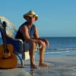 kenny chesney on the beach sitting