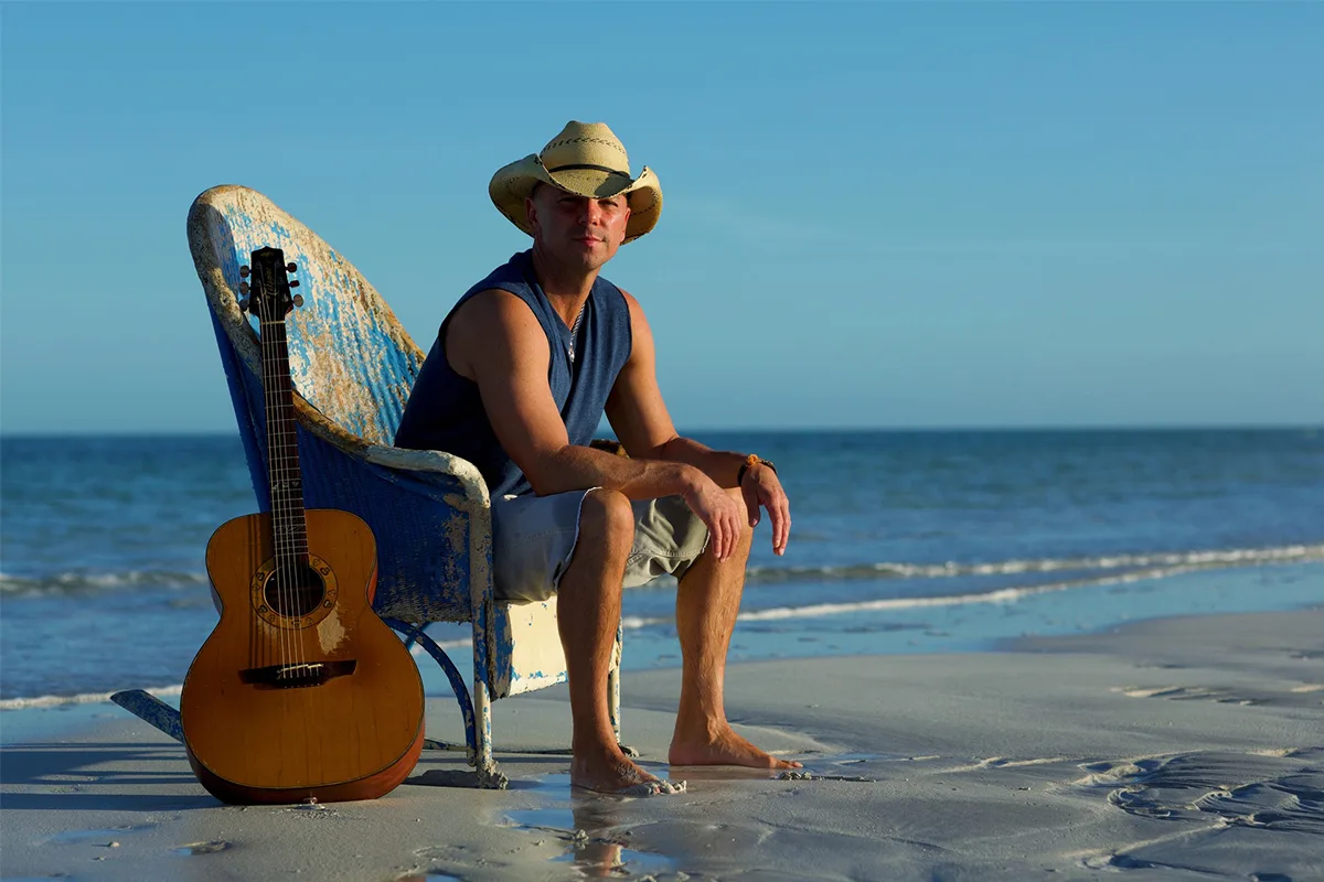 kenny chesney on the beach sitting