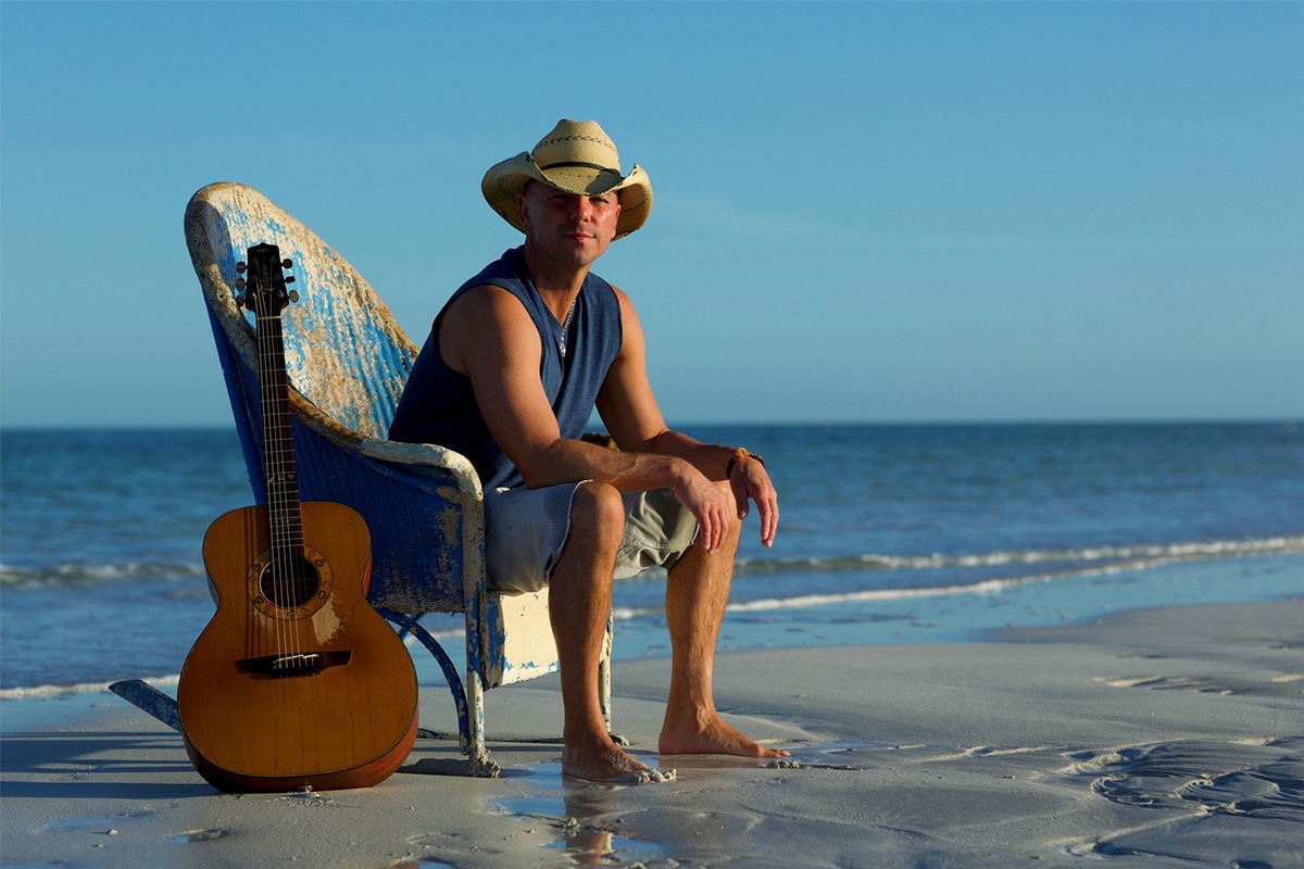 kenny chesney on the beach sitting