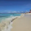 arashi beach in aruba with palapas in the background