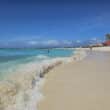 arashi beach in aruba with palapas in the background