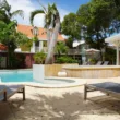 kura botanica pool with chairs and roofs