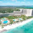 a rendering of the resort with beach and blue water