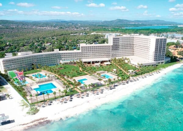 a rendering of the resort with beach and blue water