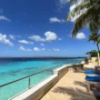 blue water next to chairs and a balcony