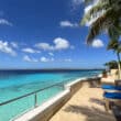 blue water next to chairs and a balcony