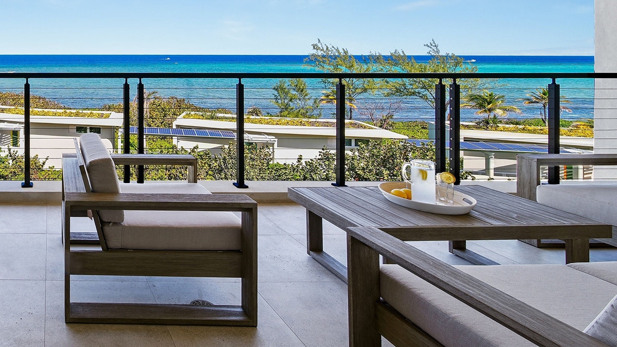 terrace with blue water and chairs