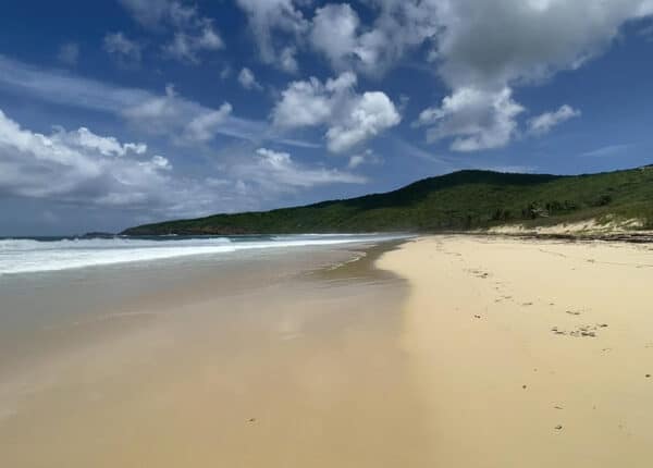playa resaca culebra beach with green hills and clouds in blue sky