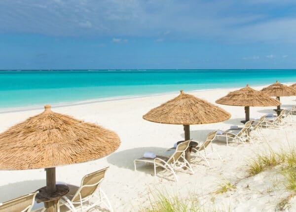 palapas on grace bay beach in turks and caicos