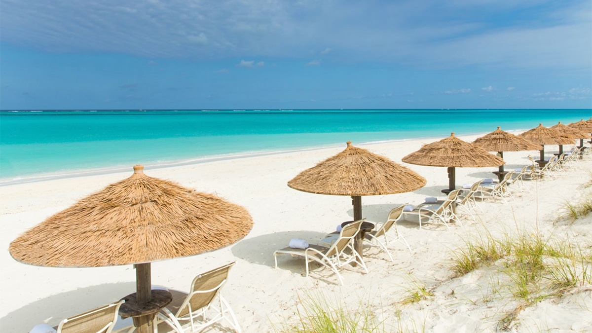 palapas on grace bay beach in turks and caicos