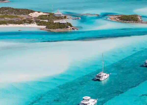 boats in turquoise water in abaco bahamas