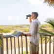 aruba guest with binoculars in nature lodge