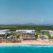 punta cana beach with resort and mountains in background