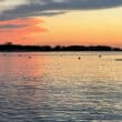 a paddleboarder at sunset on paradise island