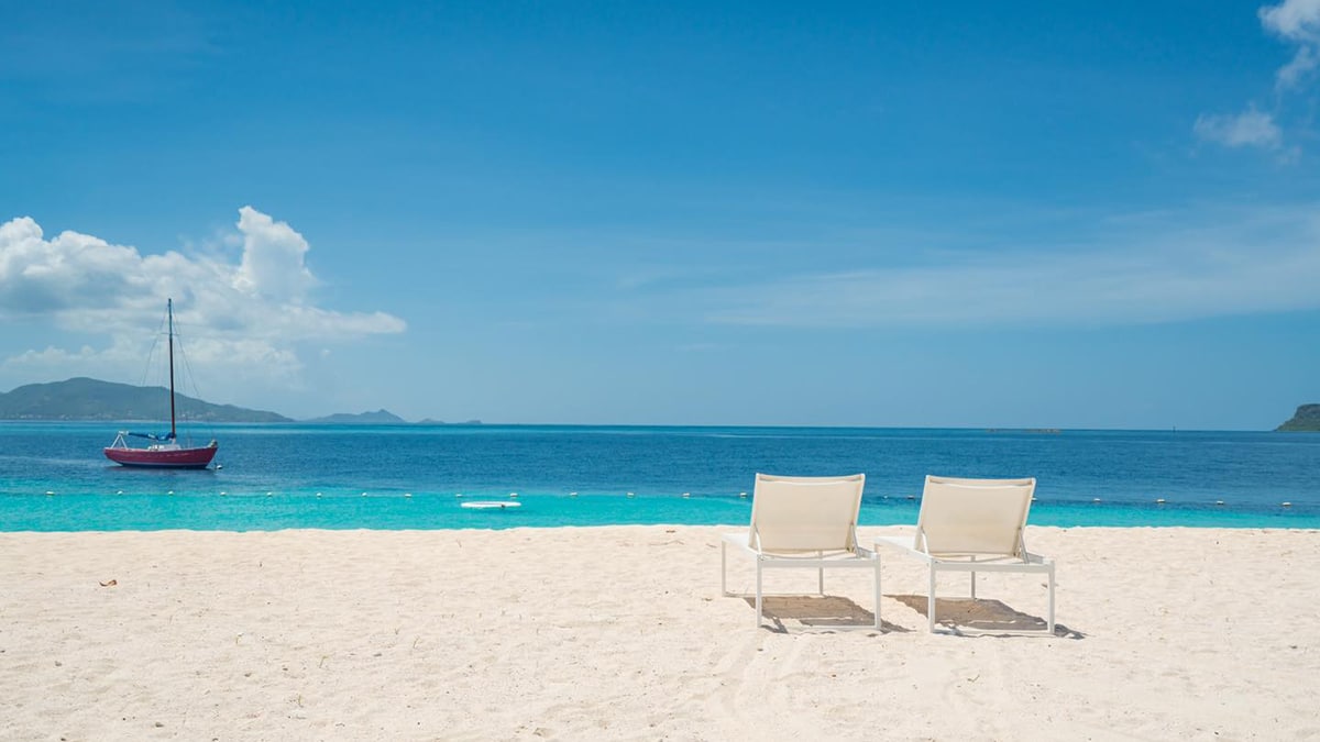 palm island grenadines chairs on beach