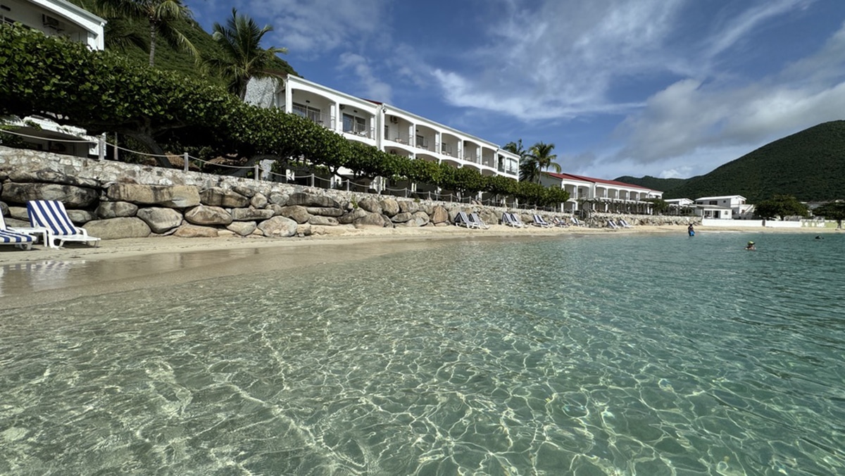 caribbean beach with resort rooms in background