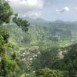 a village surrounded by green hills in dominica