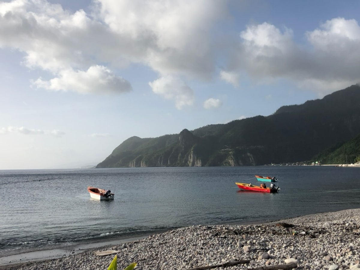 green hills and boats in the water