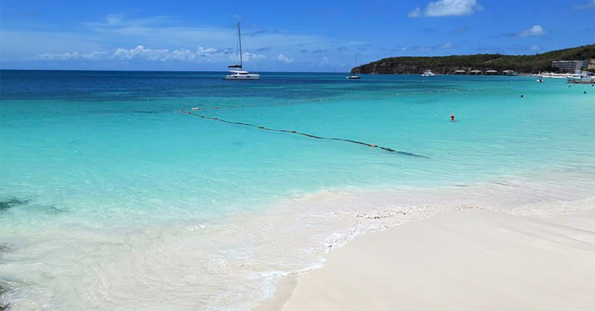 This Antigua Beach Is One of the Most Beautiful in the Caribbean and It’s Perfect for Summer Travel —With an Iconic Red Phone Booth, Brilliant Blue Water, and a Timeless Feel