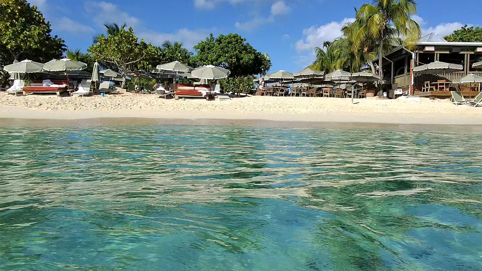 Grand Cayman’s Seven Mile Beach Has a Peculiar Magic: Emerald Water, Swaying Palms, and a Healing Legend